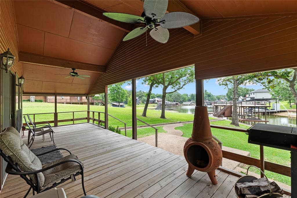 1524 Villa Cove Drive, Tool, TX 75143 Inviting wraparound covered porch overlooking the water—perfect for morning coffee, evening sunsets, or entertaining friends and family.