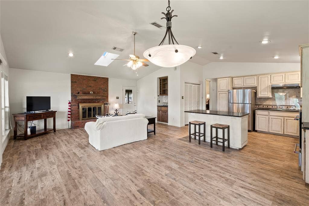 1524 Villa Cove Drive, Tool, TX 75143 Spacious living area highlighting seamless flow from living to kitchen and dining, perfect for entertaining or relaxing with family and friends.