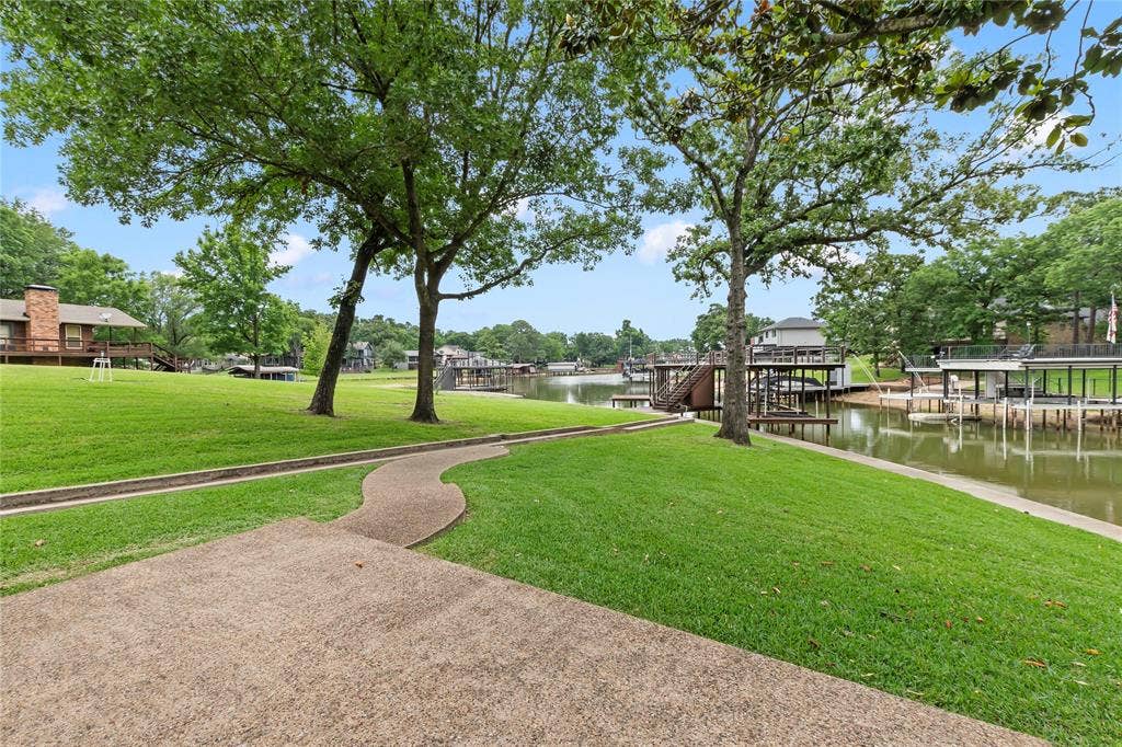 1524 Villa Cove Drive, Tool, TX 75143 Lush, green backyard with plenty of open space, perfect for outdoor fun, relaxing afternoons, or entertaining, all overlooking your private lakefront and shimmering water views.