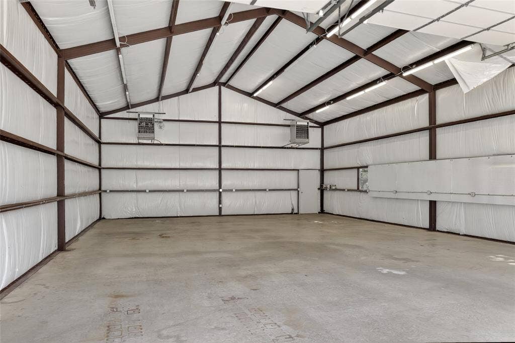 690 Orchid Hill Lane, Copper Canyon, TX 76226 Inside view of the 30x50 heated workshop. On the outside of the workshop there's a parking pad right next to it for additional RV parking