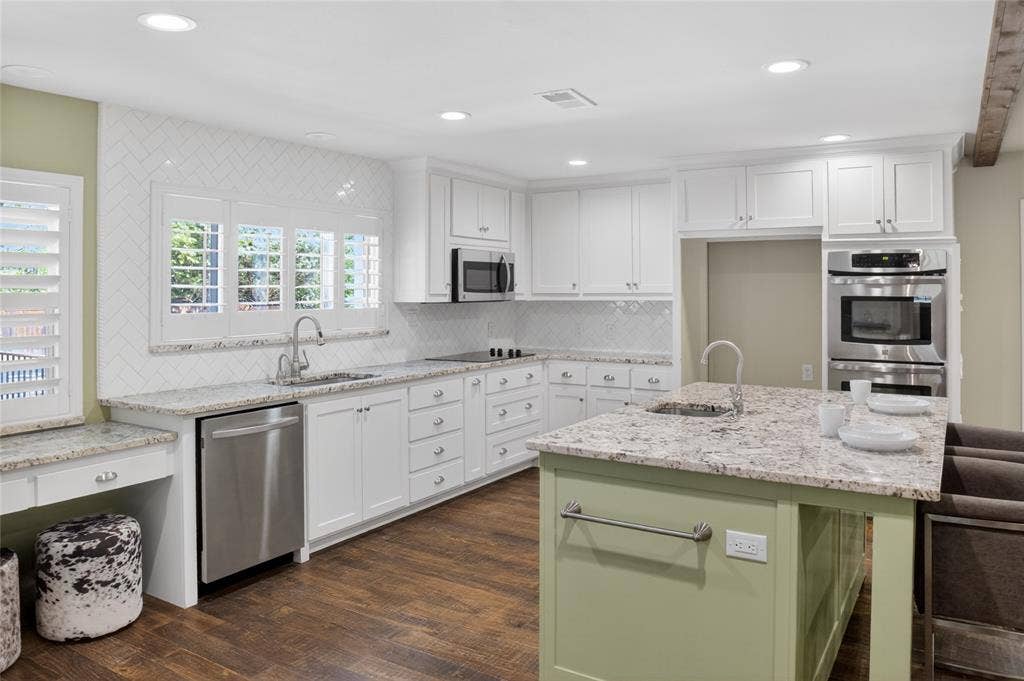 690 Orchid Hill Lane, Copper Canyon, TX 76226 Updated kitchen features a double oven, farm sink, utility desk and a large island with a second sink