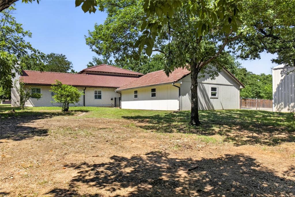 690 Orchid Hill Lane, Copper Canyon, TX 76226 View of the home from the back. Home sits on 3.26 acres and back to Poindexter Creek