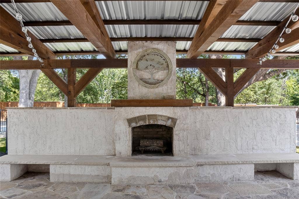 690 Orchid Hill Lane, Copper Canyon, TX 76226 This outdoor living area is one of the greatest features of this home! It has wood burning fireplace, fenced in dog run, with direct access from the kitchen.