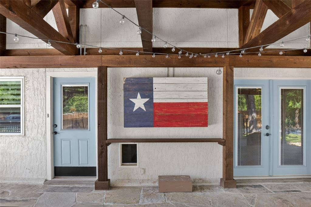 690 Orchid Hill Lane, Copper Canyon, TX 76226 Another view of the outdoor living area looking back from the fireplace into the kitchen or secondary bedroom area/flex room. The Texas flag is a box that can accommodate a large TV, which keeps it protected from the weather