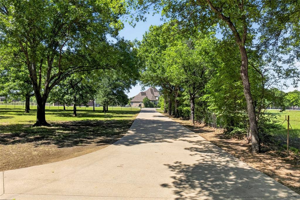 690 Orchid Hill Lane, Copper Canyon, TX 76226 View of driveway looking towards entry gate