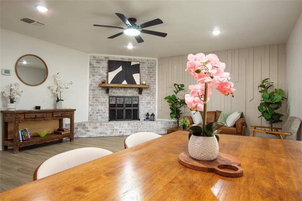1205 Augusta Road, Benbrook, TX 76126 Living area featuring a white-washed brick fireplace with a wood mantle, ceiling fan, recessed lighting, and wood-finish flooring
