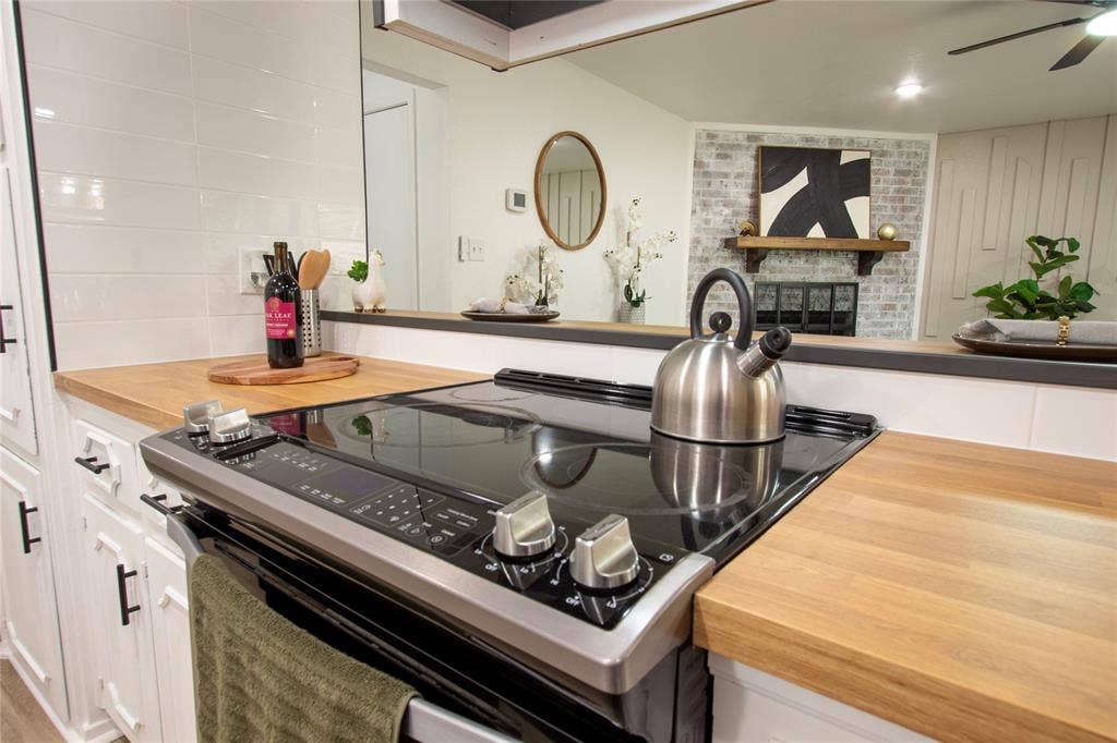 1205 Augusta Road, Benbrook, TX 76126 Modern kitchen featuring wood-finish countertops and a black electric range