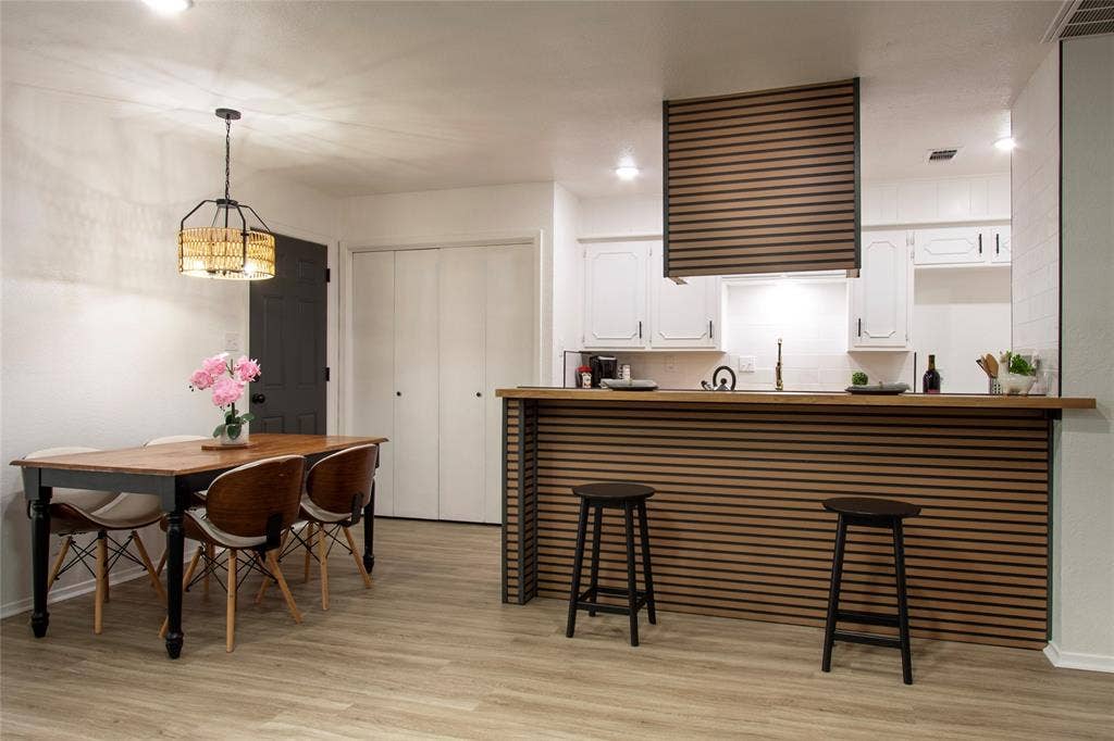 1205 Augusta Road, Benbrook, TX 76126 Kitchen bar with horizontal wood slat detailing and a coordinating wood countertop