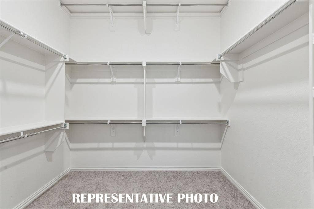 1026 Splitrock Drive, Allen, TX 75013 With outstanding space and seasonal hanging racks, your dream owner's closet awaits!! REPRESENTATIVE PHOTO