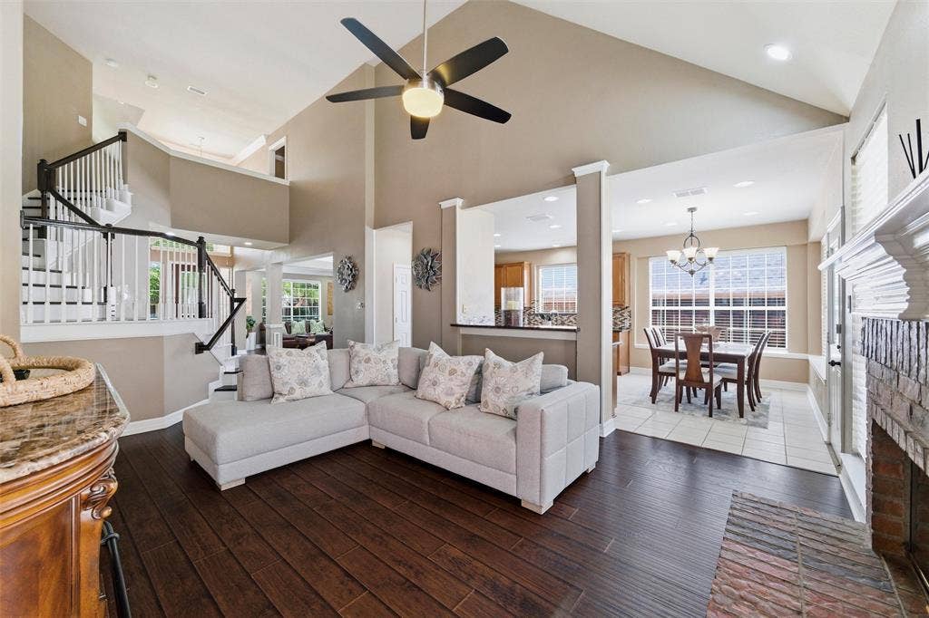 1432 Honey Locust Drive, Plano, TX 75023 Family Rm has engineered wood, soaring ceiling, brick fireplace with gas start, elegant wood stairs, open to kitchen.