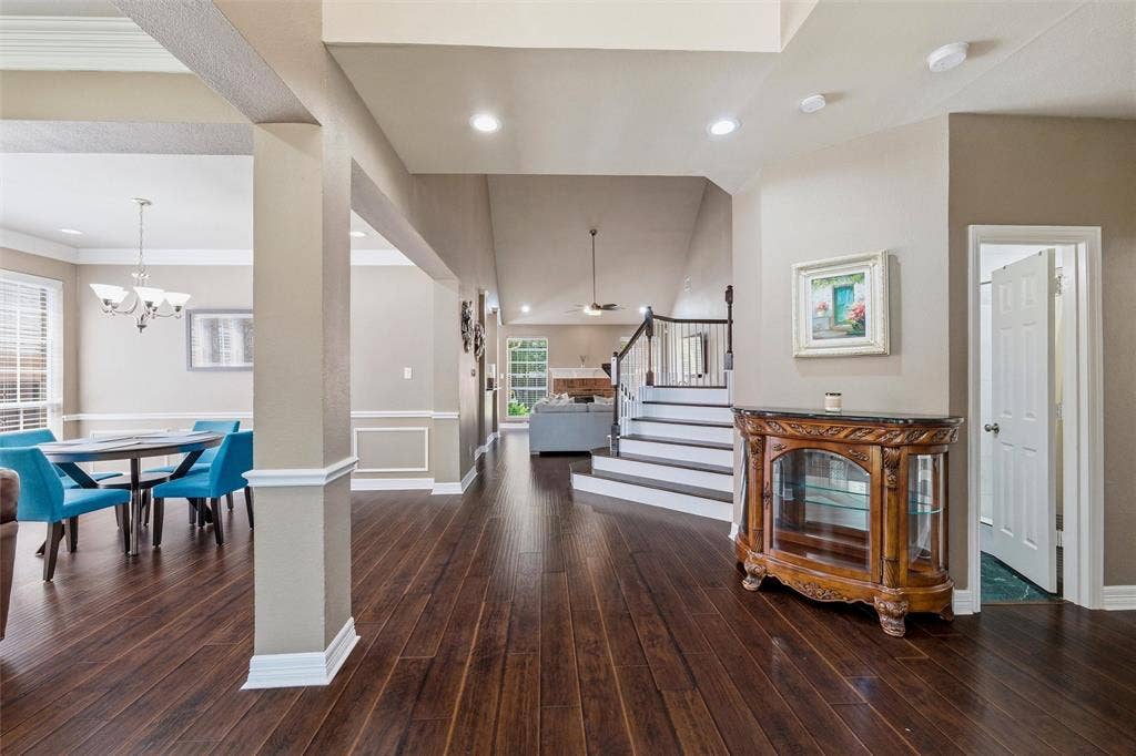 1432 Honey Locust Drive, Plano, TX 75023 Engineered wood, stairs with white risers. Stacked formals to left, Study or BdRm 2 with French doors to right, Full Hall Bath at door to right. Primary Suite to right.
