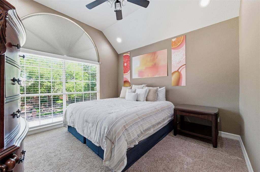 1432 Honey Locust Drive, Plano, TX 75023 Front bedroom 3 with vaulted ceiling, recessed lighting, ceiling fan, and gorgeous arched window.