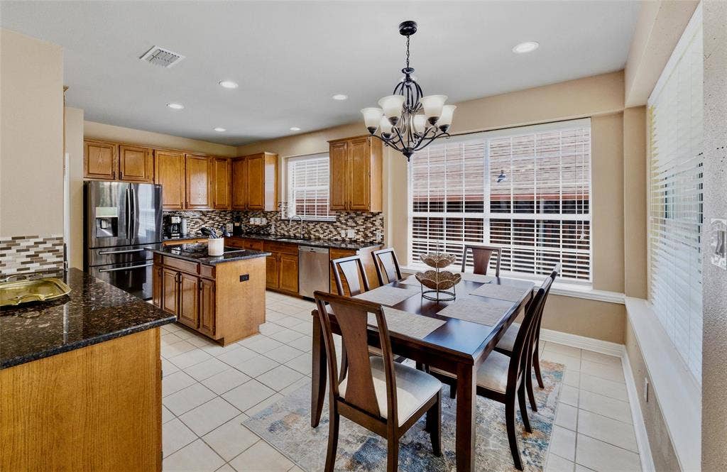 1432 Honey Locust Drive, Plano, TX 75023 Large eat in kitchen with granite counters and quality glass mosaic backsplash. Lots of storage with 42in cabinets.