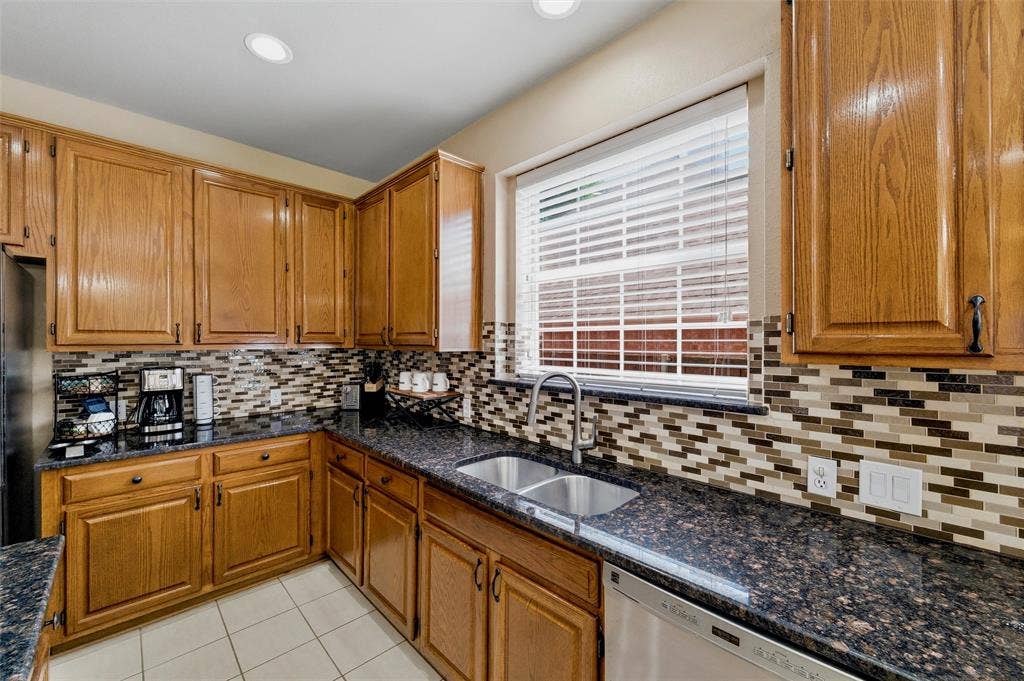 1432 Honey Locust Drive, Plano, TX 75023 Stainless steel dishwasher, undermount sink and pull down faucet.