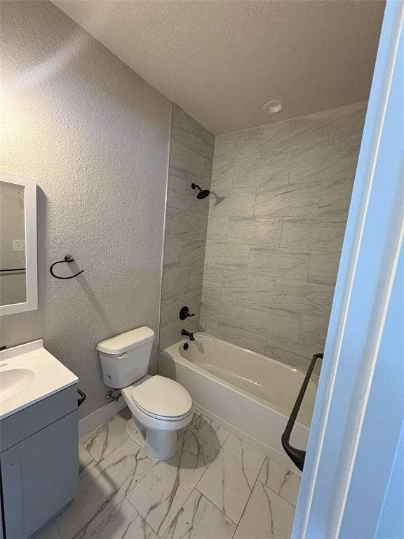 316 Henry Street, Waxahachie, TX 75165 Bathroom featuring a tiled shower surround, integrated bathtub, and white vanity with a single basin