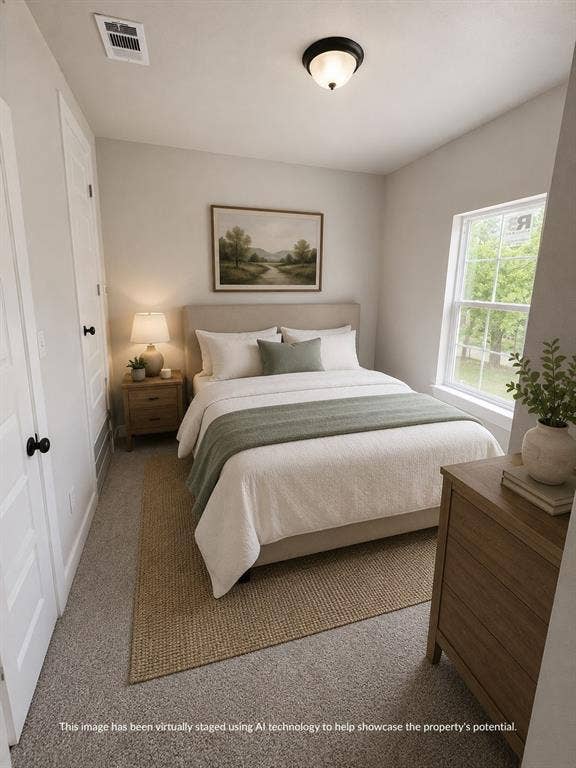 316 Henry Street, Waxahachie, TX 75165 Neutral-toned bedroom featuring a double-hung window, light gray carpeting, and a flush-mount ceiling light fixture
