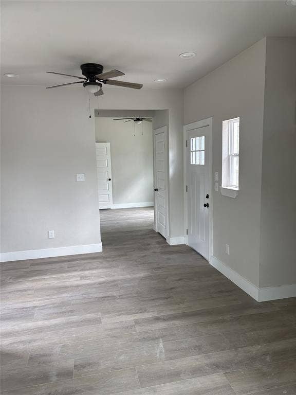 316 Henry Street, Waxahachie, TX 75165 Light-filled interior featuring wood-finish flooring, recessed lighting, ceiling fan, white baseboards, and a paneled front door with divided lites