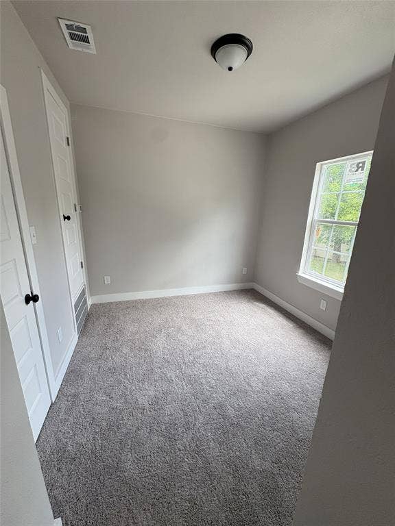 316 Henry Street, Waxahachie, TX 75165 Neutral-toned room featuring a single window, two panel doors, and a ceiling-mounted light fixture