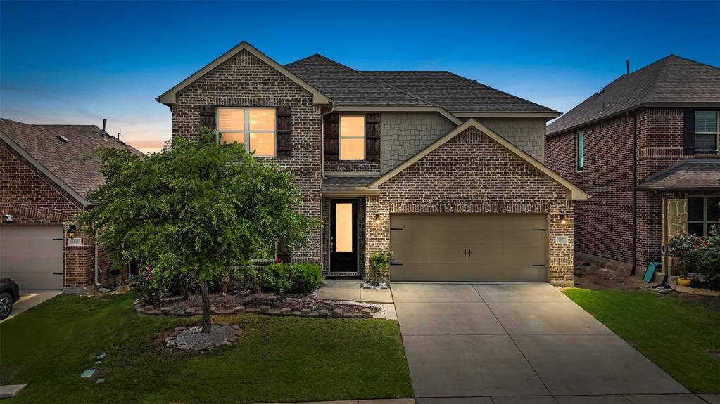 1437 Tanglewood Trail, Northlake, TX 76226 Two-story brick and siding exterior with a pitched roof and attached garage