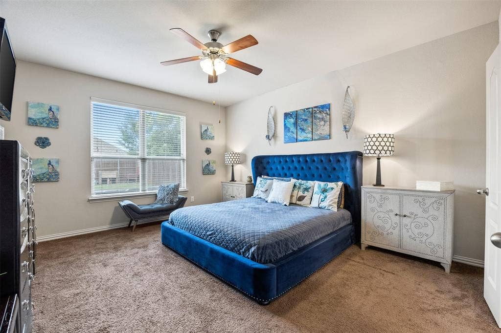1437 Tanglewood Trail, Northlake, TX 76226 Spacious room with plush carpeting, a large window with blinds, and a ceiling fan with integrated lighting