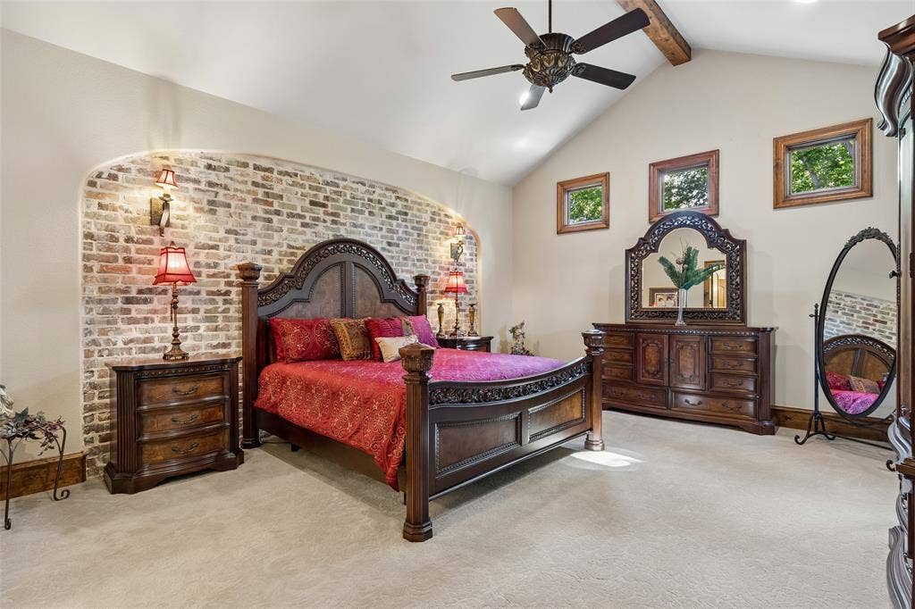 125 Audrey Drive, Keller, TX 76248 Primary bedroom with ceiling fan, vaulted ceiling, beautiful feature wall and carpet.