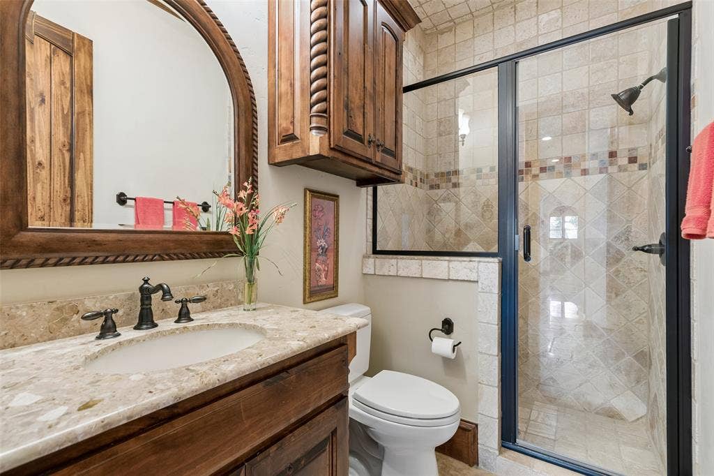 125 Audrey Drive, Keller, TX 76248 Bathroom 2 located downstairs next to bedroom 2. Granite countertops, built in cabinets and walk in shower.