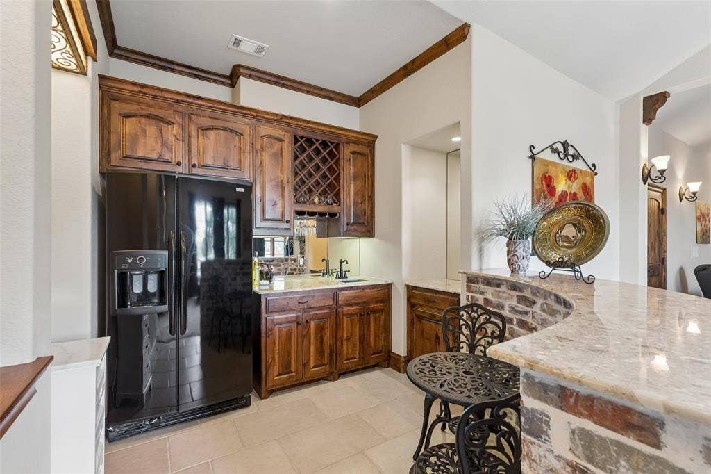 125 Audrey Drive, Keller, TX 76248 Very large flex room upstairs featuring a ceiling fan, space for media equipment and a small kitchen. Can be used for a game room or media room. Small kitchen features a full size refrigerator, a sink and plenty of cabinet space.