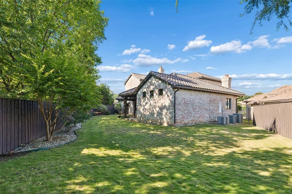 125 Audrey Drive, Keller, TX 76248 Beautifully landscaped backyard with a covered patio and flagstone walk ways.