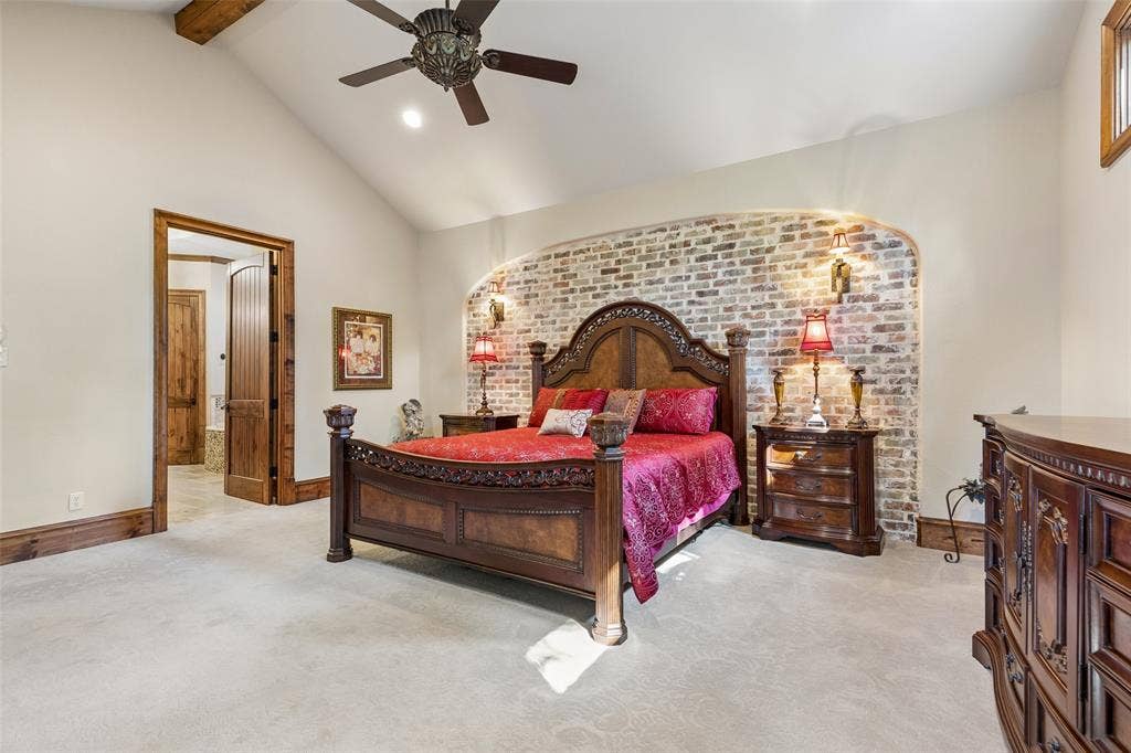 125 Audrey Drive, Keller, TX 76248 Primary bedroom with ceiling fan, vaulted ceiling, beautiful feature wall and carpet.