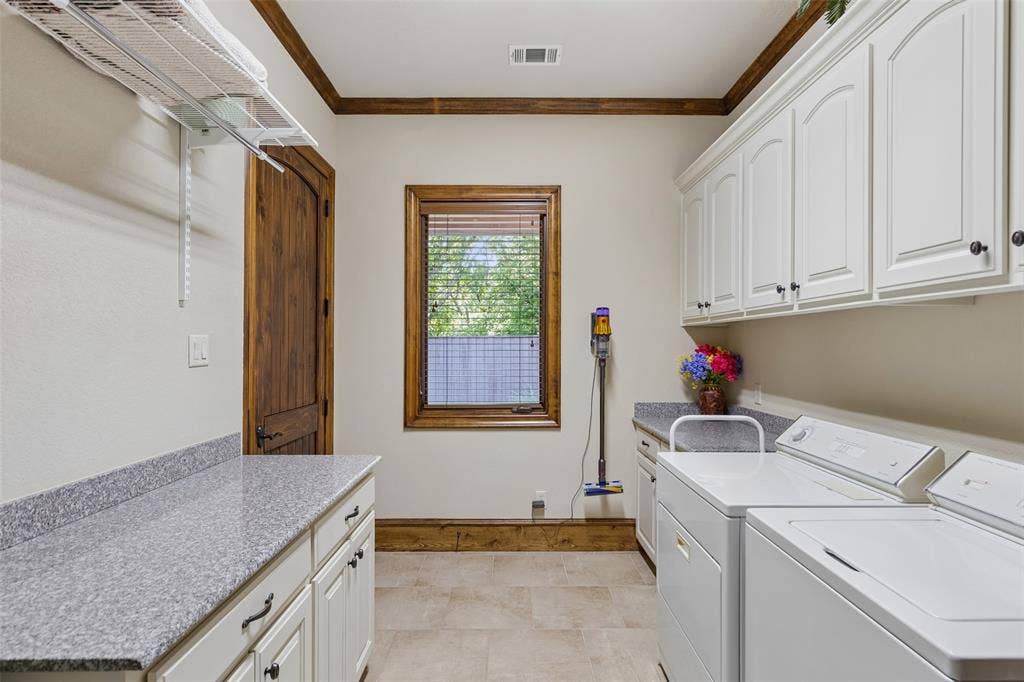 125 Audrey Drive, Keller, TX 76248 Large laundry room with built in cabinets, counter space and a utility sink.