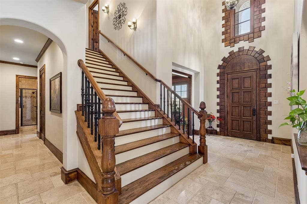 125 Audrey Drive, Keller, TX 76248 Entry view of 6 ft wide staircase and beautiful baroque door and entry window.Hallway leads to full bathroom and bedroom 2.