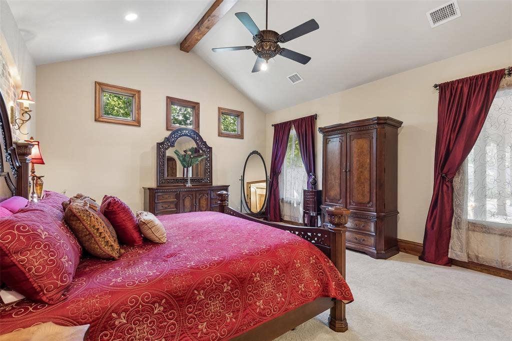 125 Audrey Drive, Keller, TX 76248 Primary bedroom with ceiling fan, vaulted ceiling, beautiful feature wall and carpet.