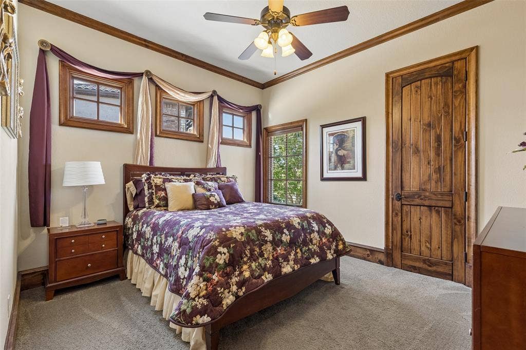 125 Audrey Drive, Keller, TX 76248 Bedroom 2 located downstairs featuring a walk in closet, ceiling fan, carpet and natural light.