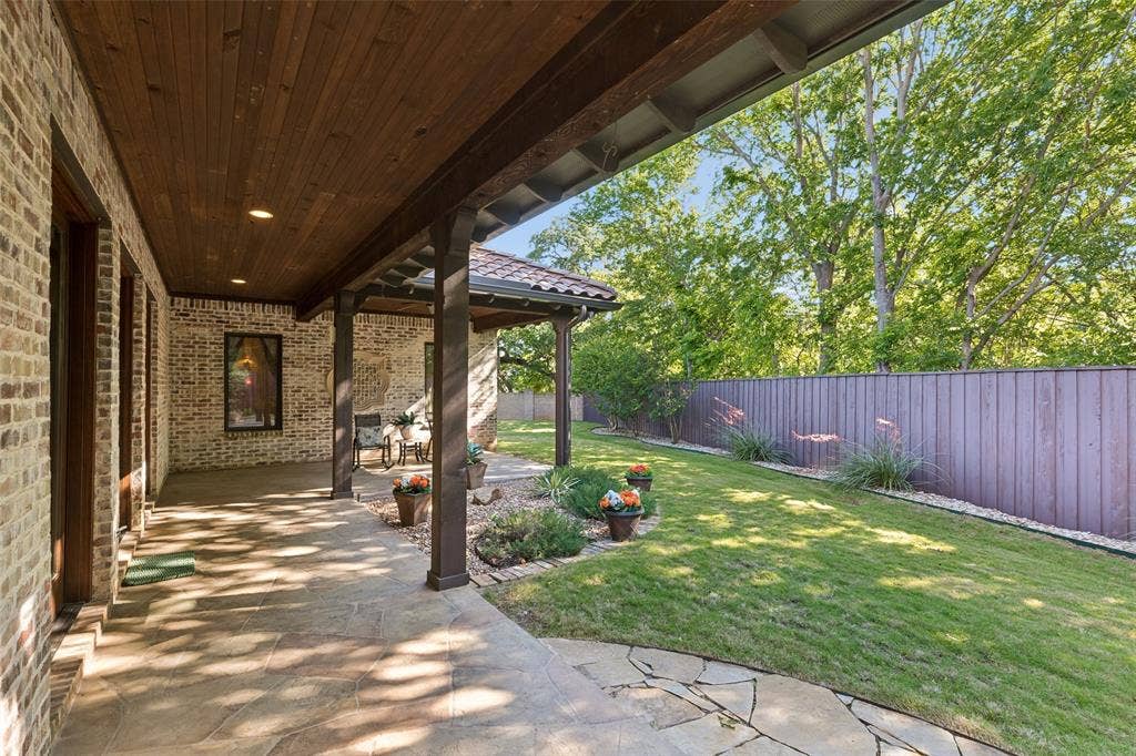 125 Audrey Drive, Keller, TX 76248 Beautifully landscaped backyard with a covered patio and flagstone walk ways.