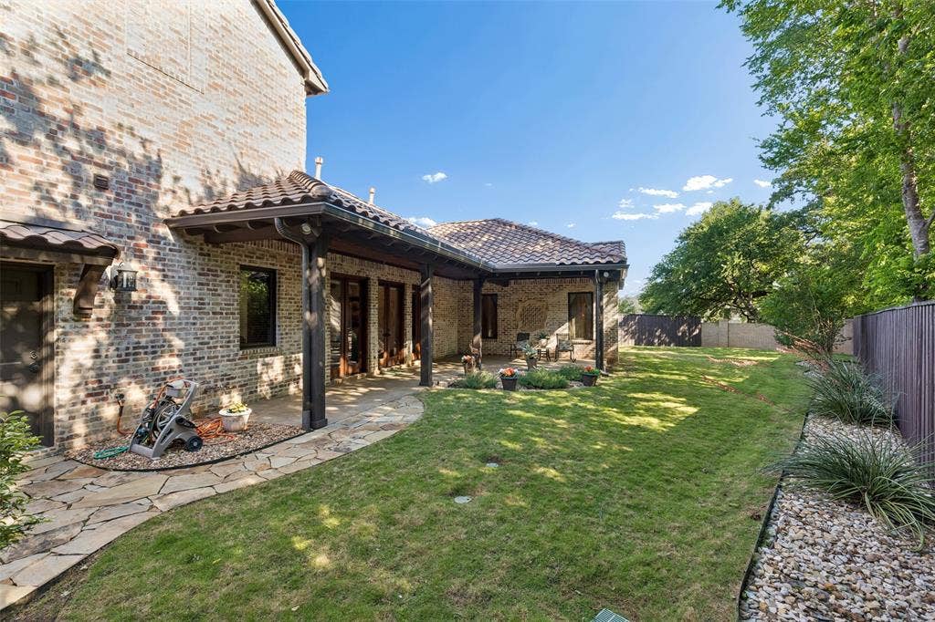 125 Audrey Drive, Keller, TX 76248 Beautifully landscaped backyard with a covered patio and flagstone walk ways.