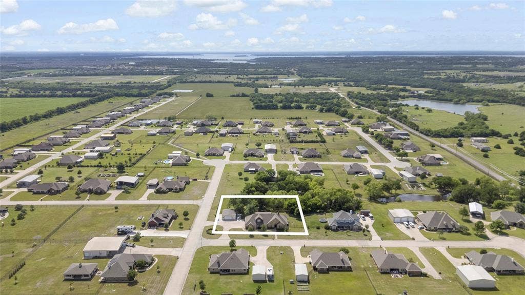544 Hubbard Circle, Nevada, TX 75173 Aerial perspective showcasing the property within a residential neighborhood with surrounding green spaces