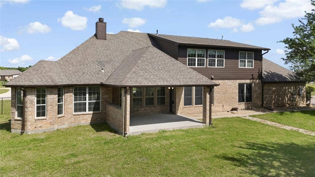 544 Hubbard Circle, Nevada, TX 75173 Brick and siding exterior featuring a covered concrete patio