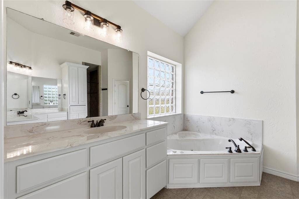 544 Hubbard Circle, Nevada, TX 75173 Spacious bathroom featuring an expansive vanity with double sinks, white cabinetry, and a light-toned countertop