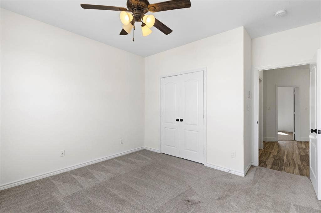 544 Hubbard Circle, Nevada, TX 75173 Room featuring light gray carpeting, a ceiling fan with integrated lighting, and white walls