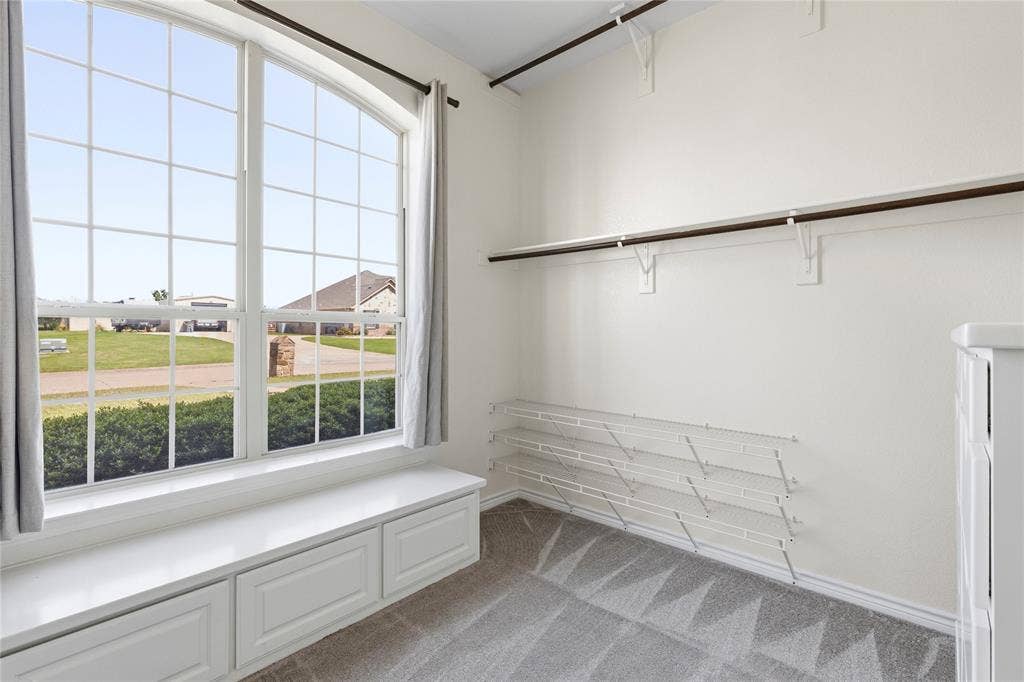 544 Hubbard Circle, Nevada, TX 75173 Arched window with grid pattern and built-in window seat featuring storage drawers