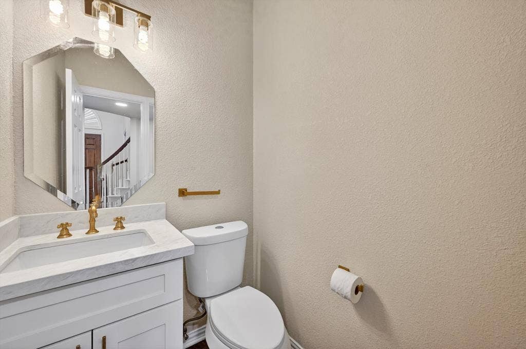 4437 Lone Tree Drive, Plano, TX 75093 Vanity featuring white cabinetry, a rectangular undermount sink, and a light-toned countertop