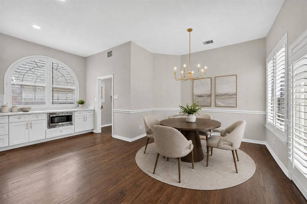 4437 Lone Tree Drive, Plano, TX 75093 Dining area featuring dark wood-finish flooring and a contemporary gold-finish chandelier