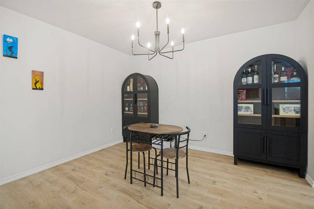 Light-toned wood-finish flooring provides a neutral base for the room