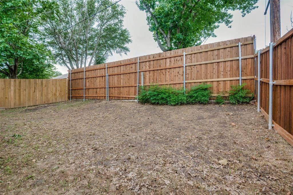 Private backyard space with wood fencing and green shrubbery