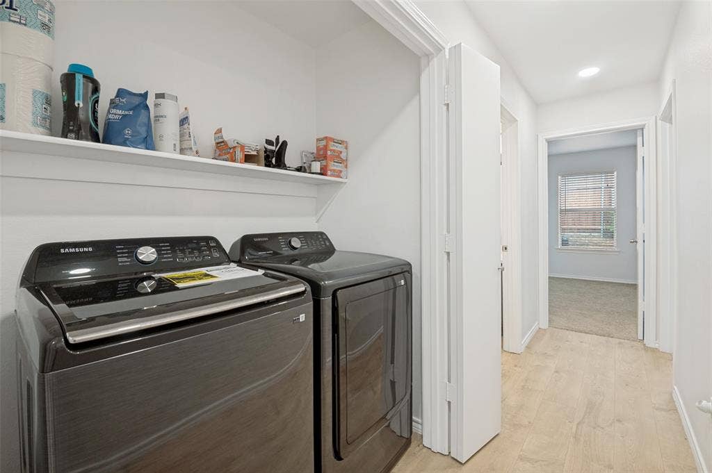 Dedicated laundry area featuring a built-in shelf, light wood-finish flooring, and recessed lighting