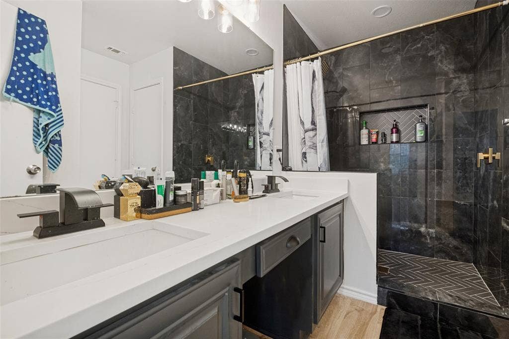 Spacious bathroom featuring a dual vanity with integrated sinks and white countertops