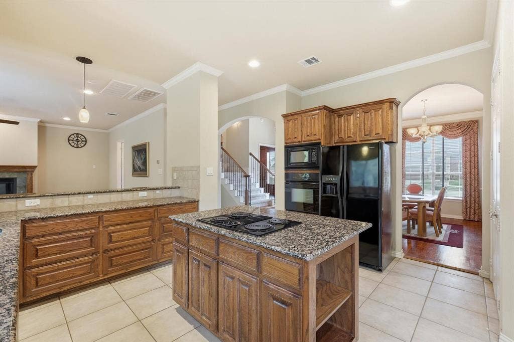 201 Fountainview Drive, Euless, TX 76039 Kitchen opens to main living and breakfast nook area and features bar stool seating on the living room side.