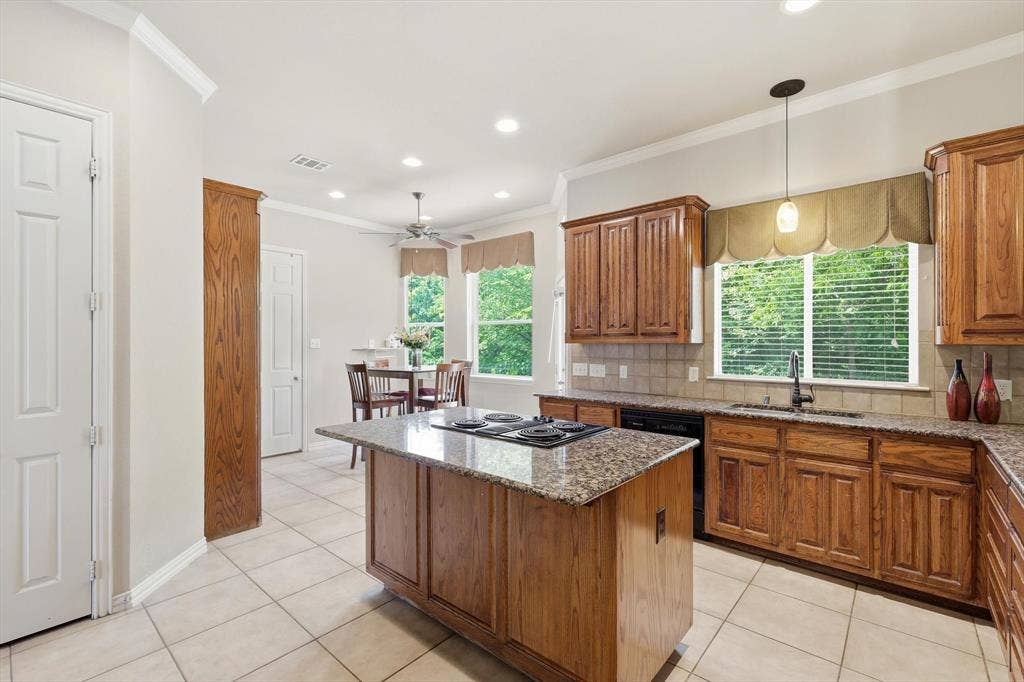 201 Fountainview Drive, Euless, TX 76039 Island feature bar stool seating and cooktop.