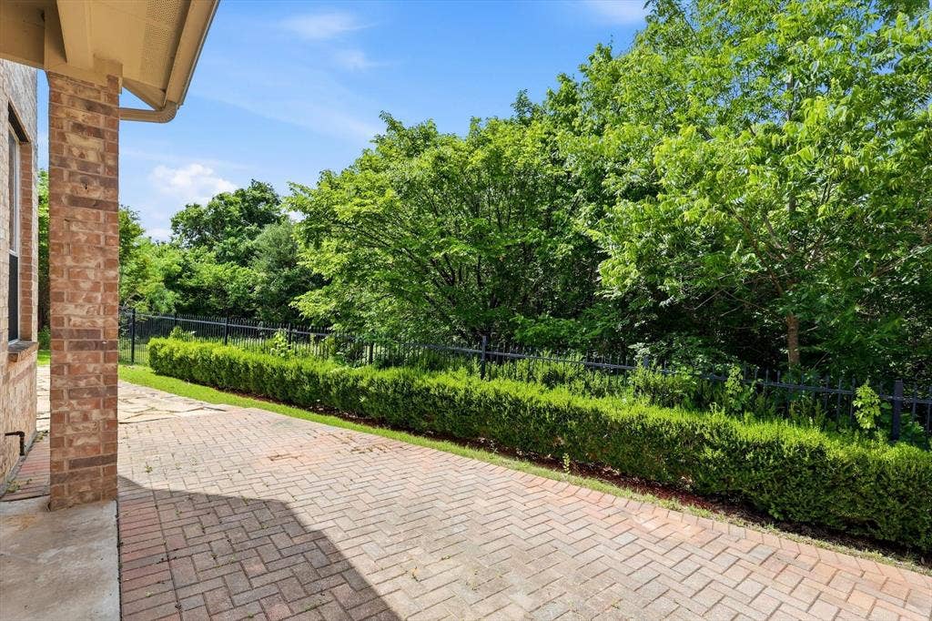 201 Fountainview Drive, Euless, TX 76039 Outdoor patio features brick pavers with a manicured hedge row. Overlooks the nature preserve.