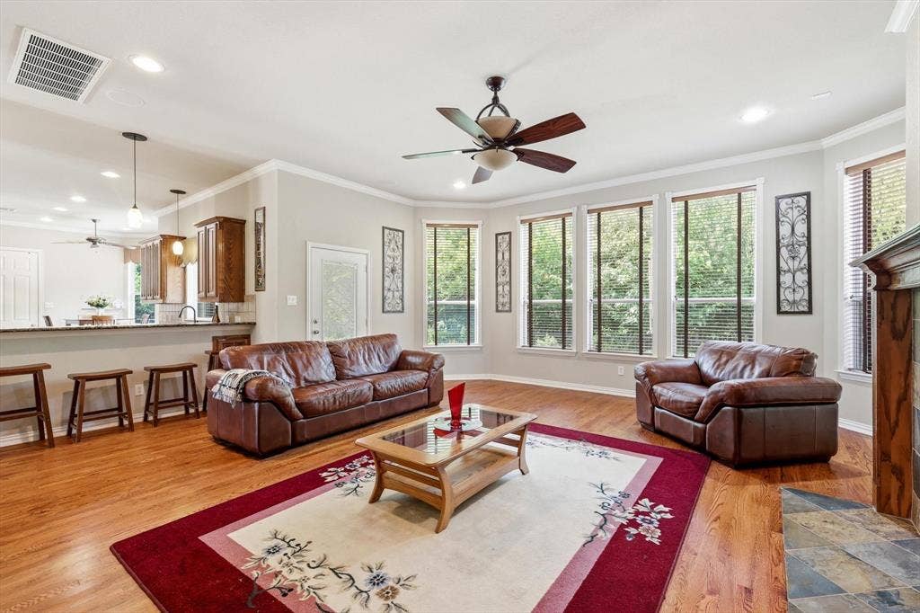 201 Fountainview Drive, Euless, TX 76039 Spacious living area featuring hardwood flooring and gas fireplace.